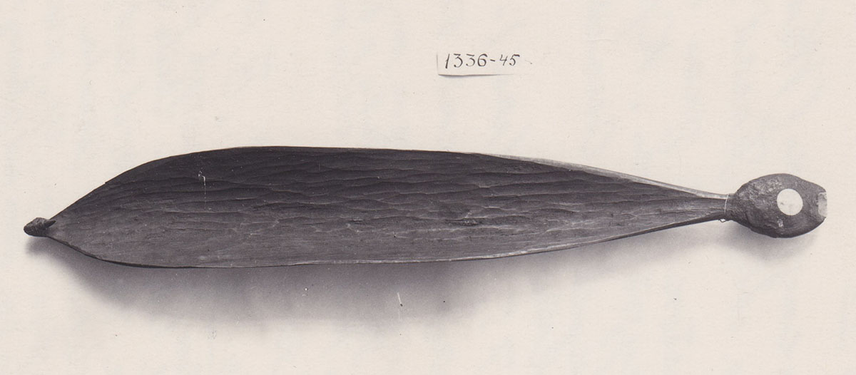 Spear-thrower with scraper